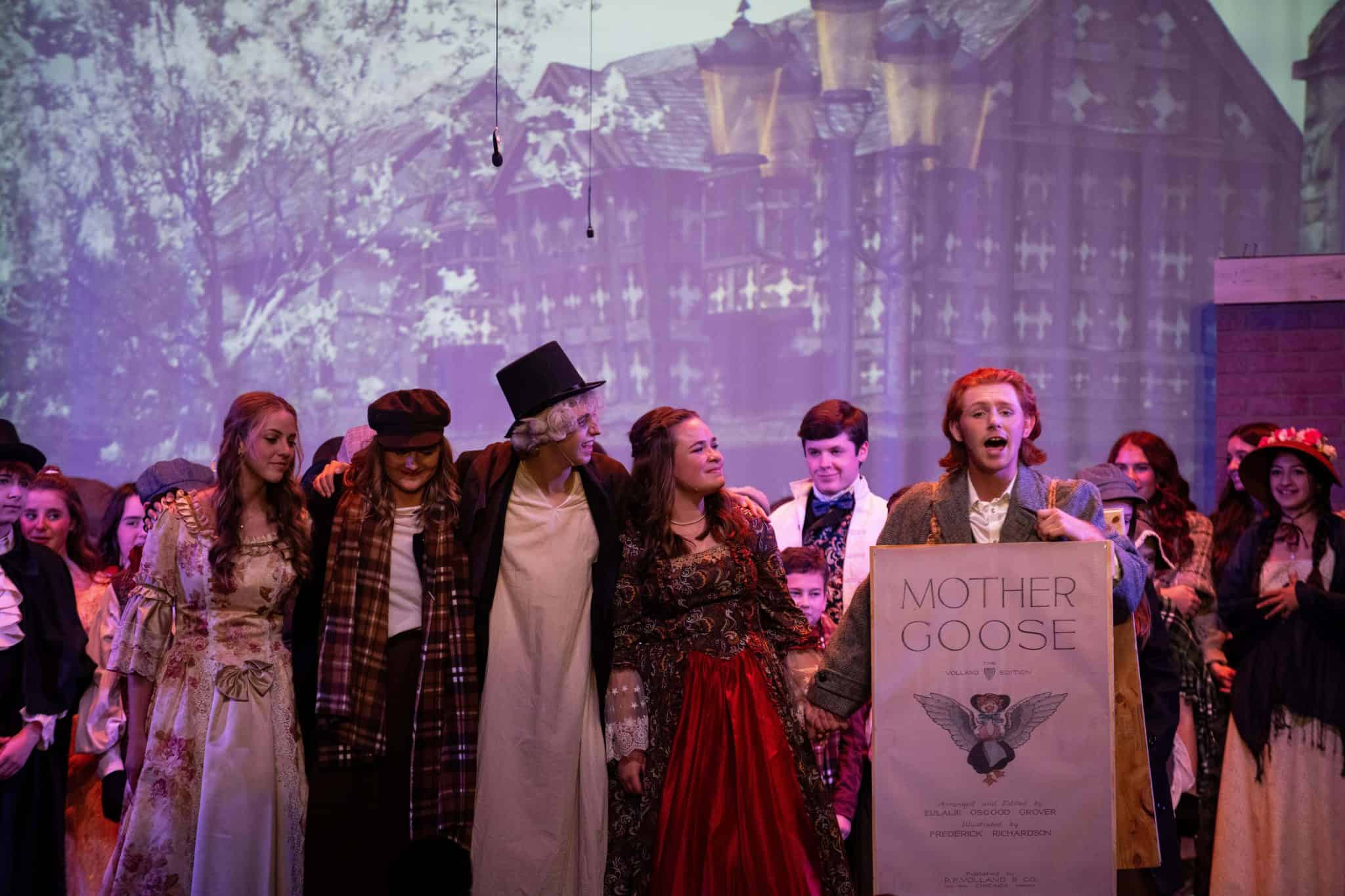 Where does the ghost of christmas present take scrooge first